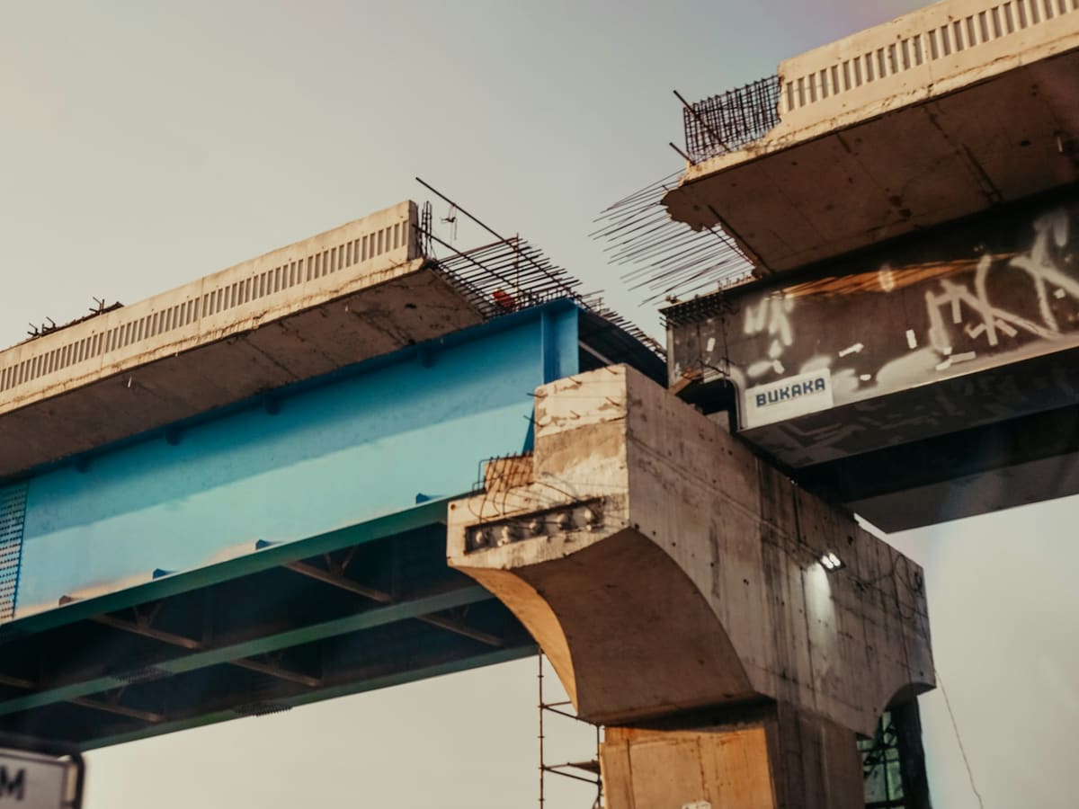 Two halves of an unfinished concrete bridge that stop short of each other