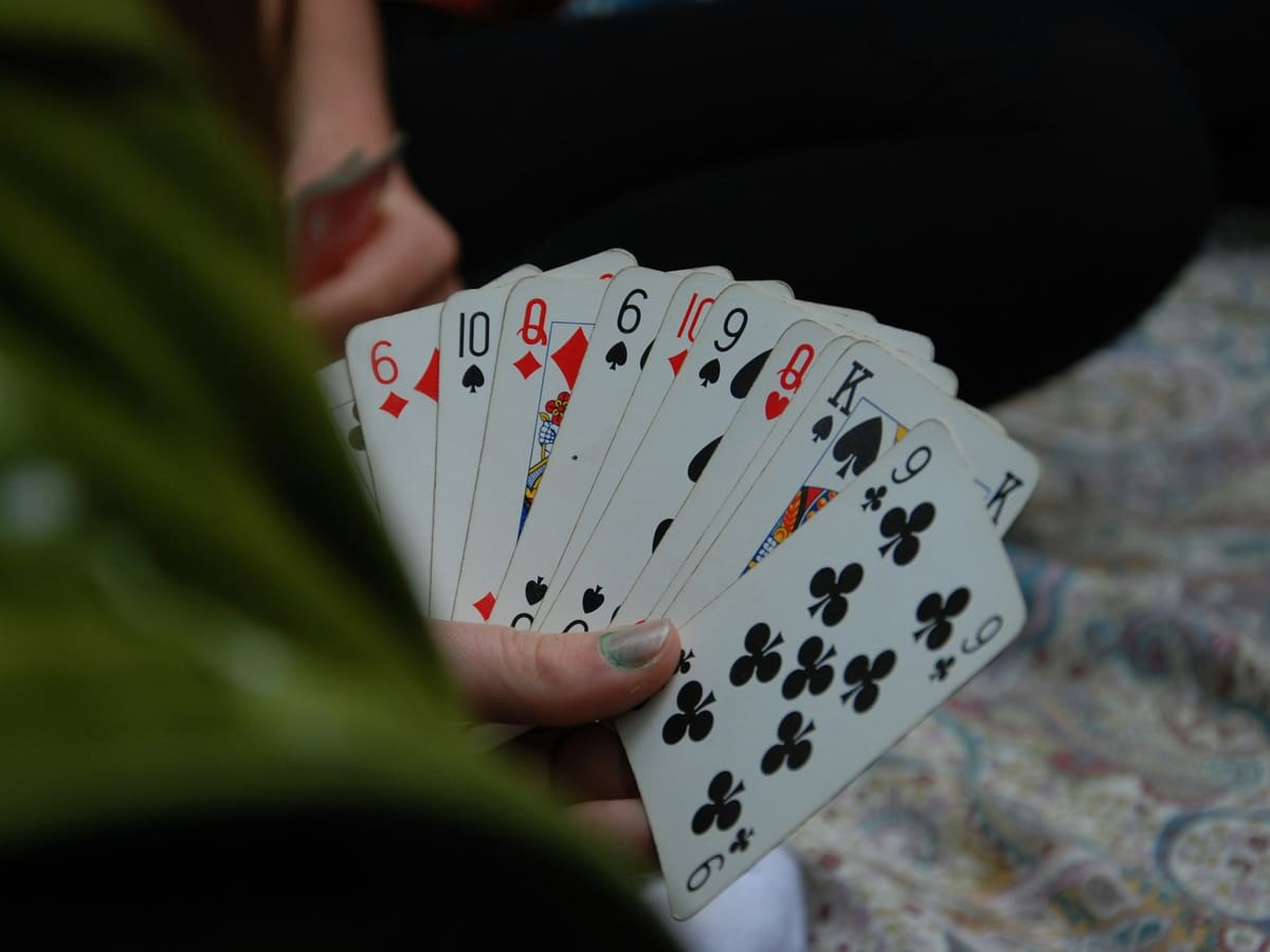 A player holding a fanned hand of playing cards close